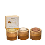 All three NB face packs open in their mango-wood vessels — Caviar Gold, Diamond Shine and Rose Pink textures side by side