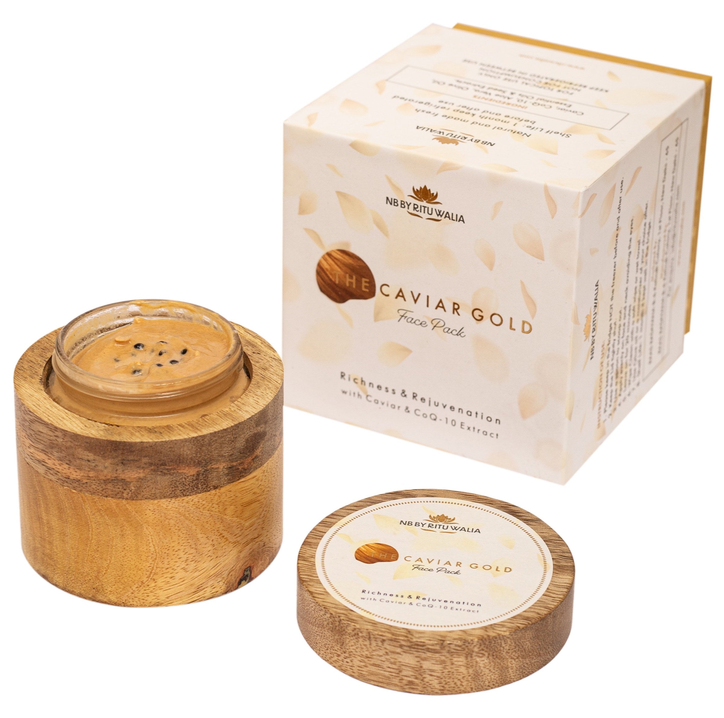 The Caviar Gold Face Pack open in its mango-wood vessel beside its box, caviar pearls visible in the golden texture