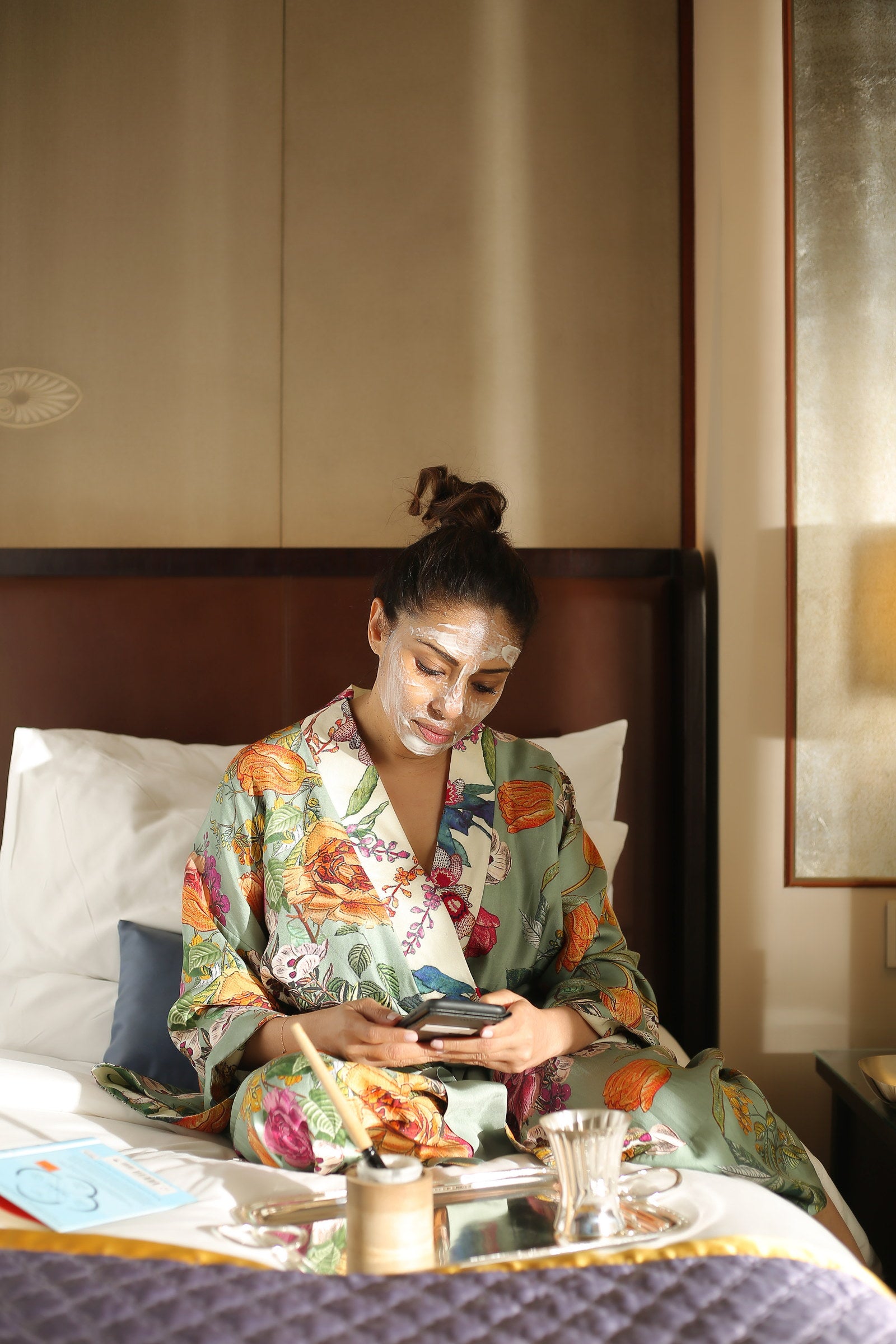The ritual observed in a hotel suite — silk robe, silver tray and a mask worn at leisure