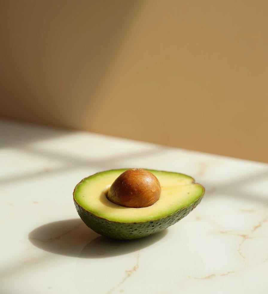 Fresh avocado halved on marble - ingredient in NB by Ritu Walia face packs