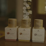 The three NB face packs on a wooden table, candlelight and warm bokeh