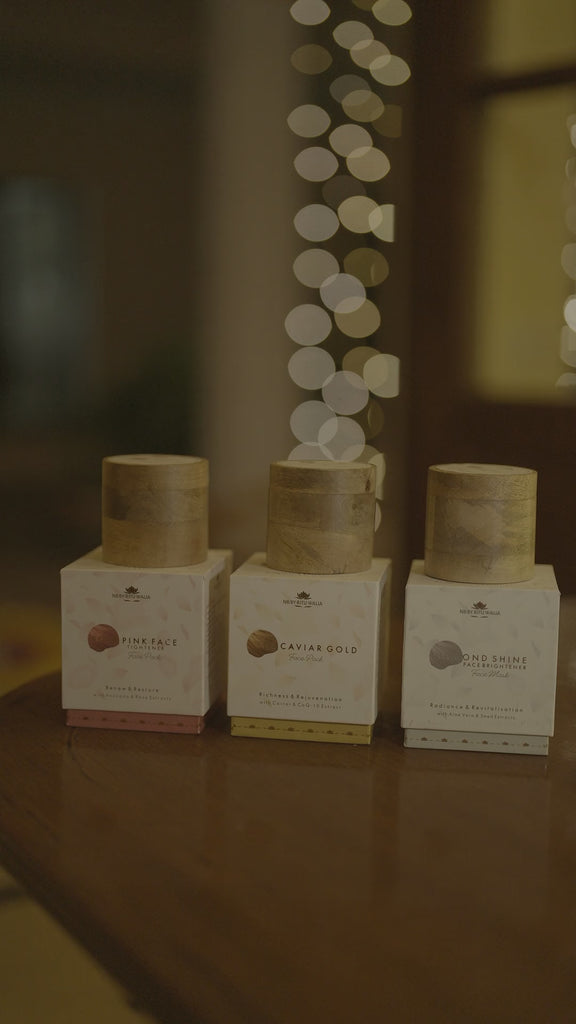The three NB face packs on a wooden table, candlelight and warm bokeh